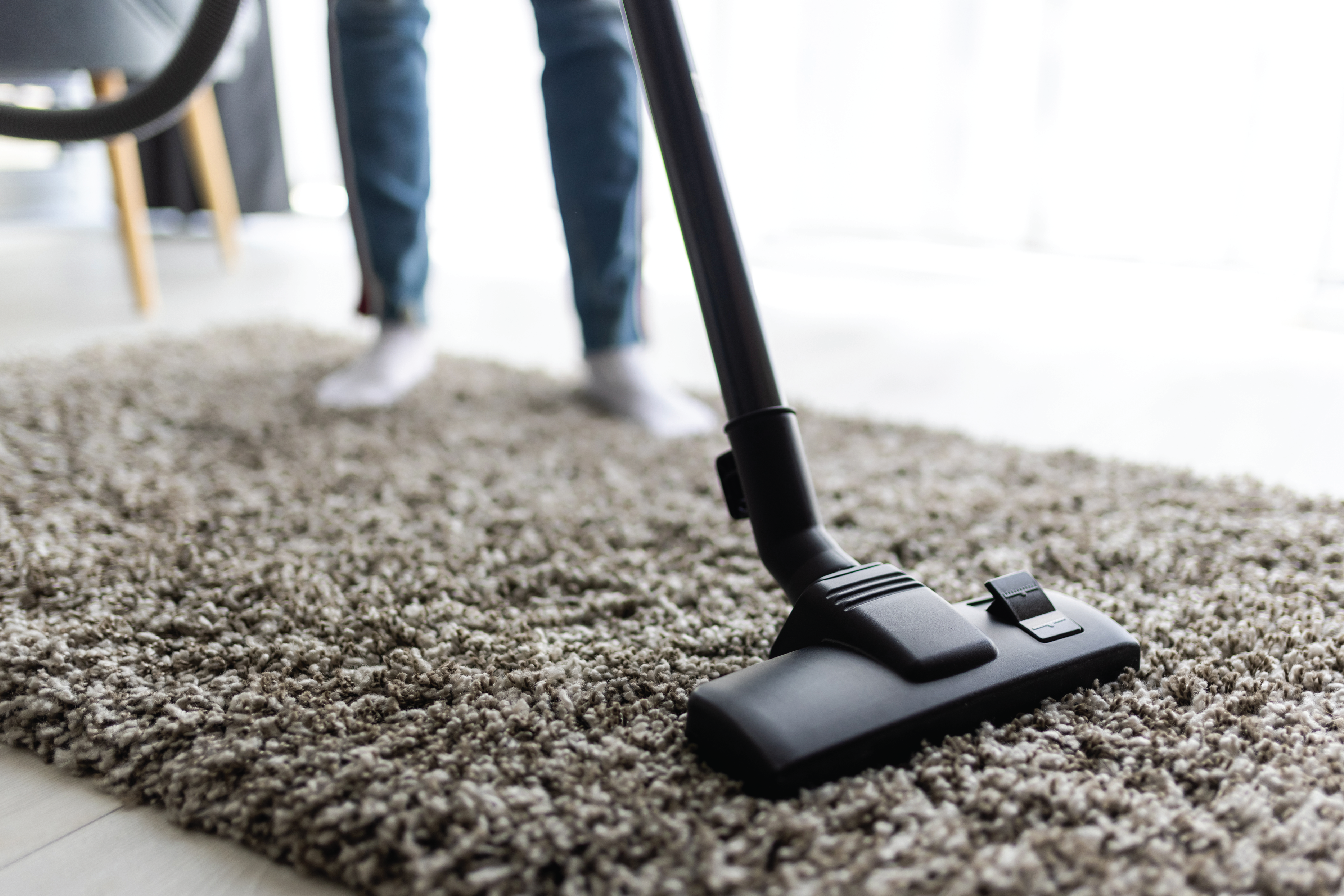 Professional cleaner working in a clean bright home in March, Cambridgeshire